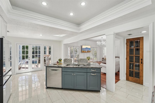 kitchen featuring a sink, french doors, a textured ceiling, and stainless steel dishwasher