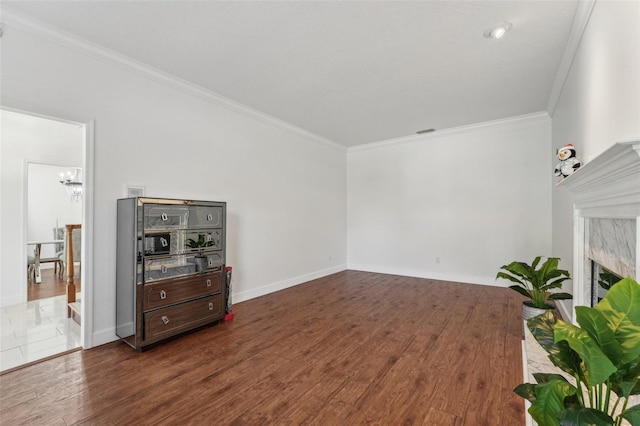 living room with a premium fireplace, ornamental molding, baseboards, and dark wood-style flooring