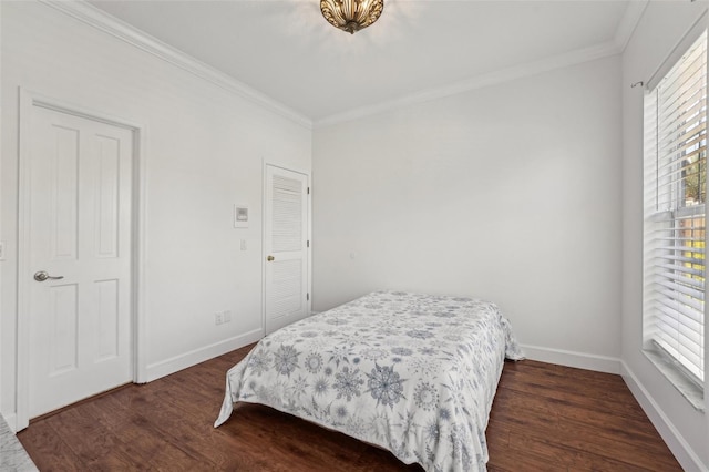 bedroom featuring dark wood finished floors, baseboards, and ornamental molding