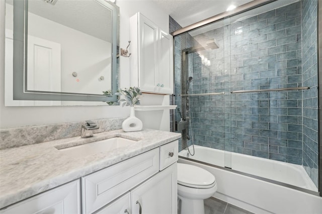 full bathroom featuring vanity, toilet, tile patterned flooring, and enclosed tub / shower combo