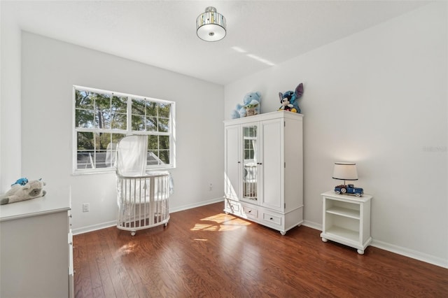 unfurnished bedroom featuring baseboards and hardwood / wood-style flooring