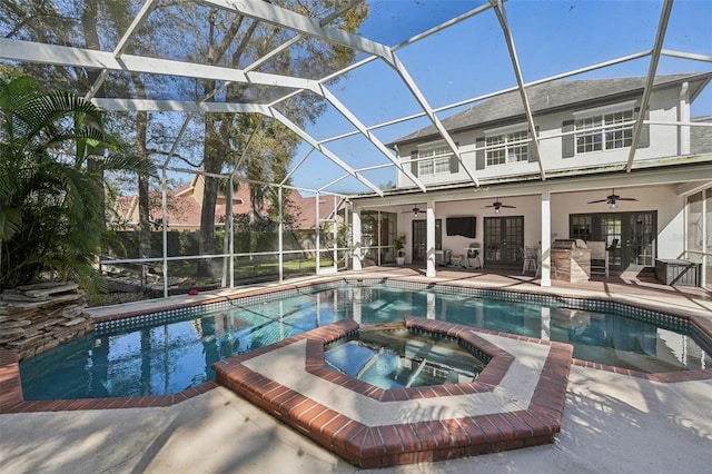 view of swimming pool featuring a patio, french doors, a pool with connected hot tub, and a lanai