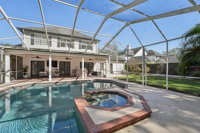 view of swimming pool with a lanai, french doors, a ceiling fan, and a patio