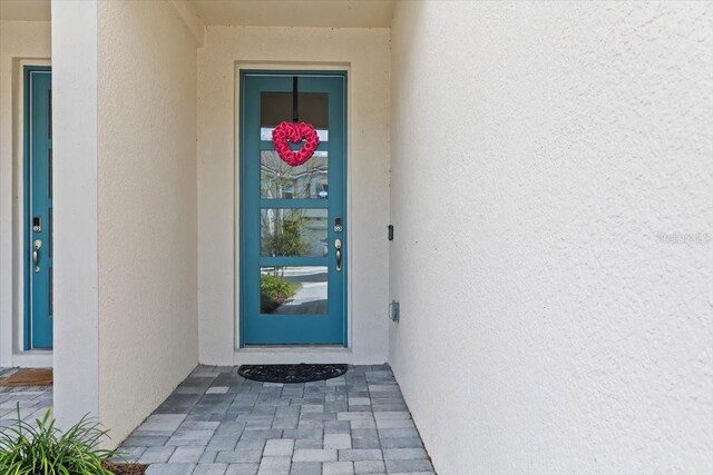 property entrance with stucco siding