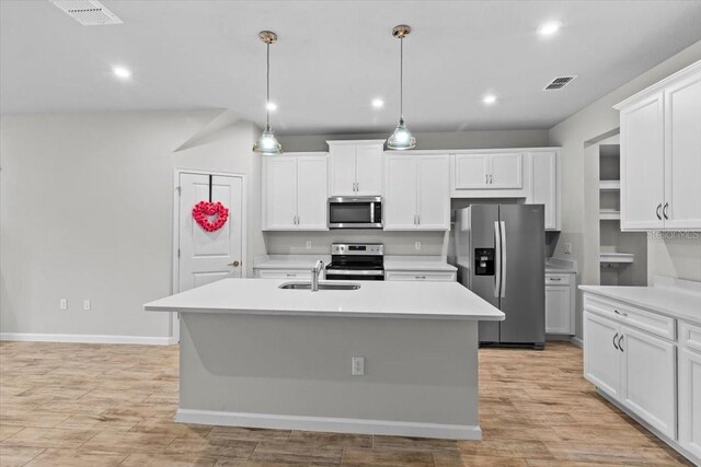 kitchen featuring light countertops, appliances with stainless steel finishes, a sink, and visible vents