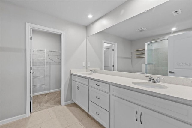 full bathroom featuring visible vents, a sink, a shower stall, and double vanity