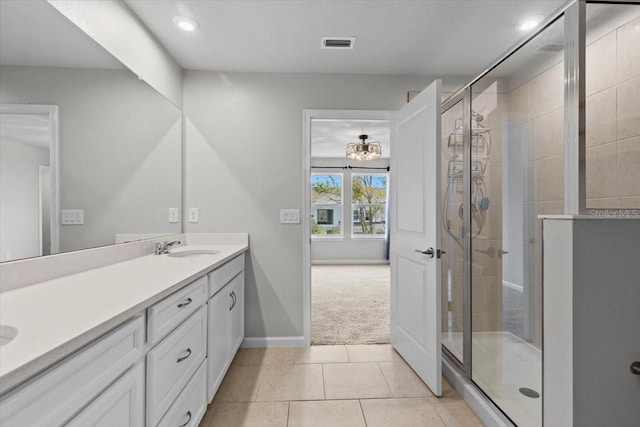 full bath featuring double vanity, a stall shower, tile patterned flooring, and visible vents