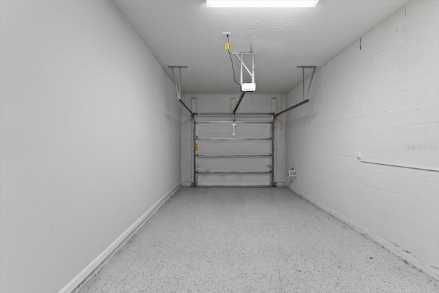 garage with a garage door opener and baseboards