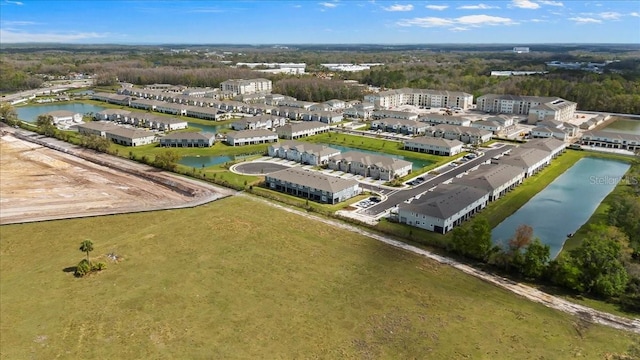 birds eye view of property featuring a water view and a residential view