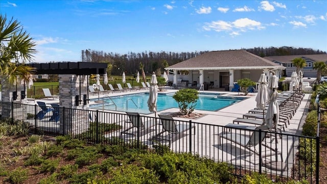 pool with a patio area and fence