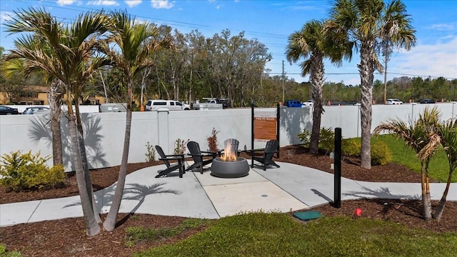 view of patio / terrace with a fire pit and fence private yard