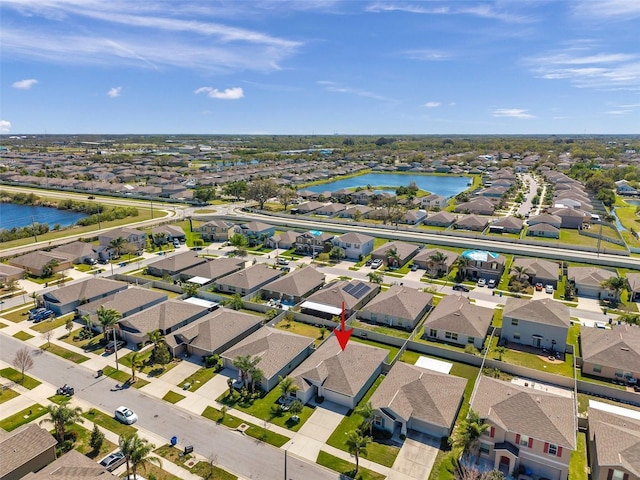 bird's eye view featuring a water view and a residential view