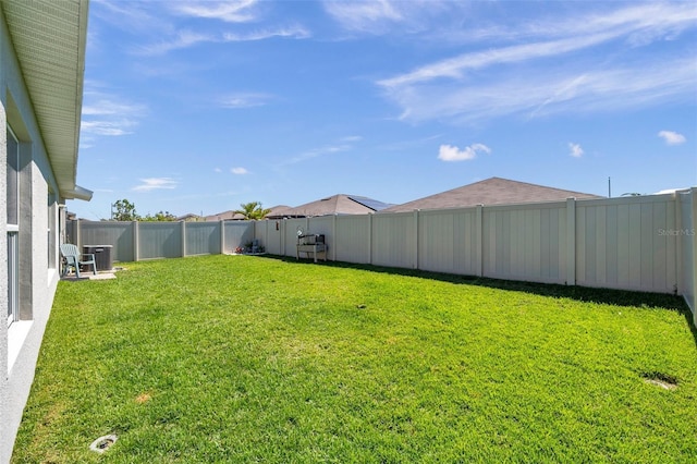 view of yard featuring a fenced backyard and central AC unit