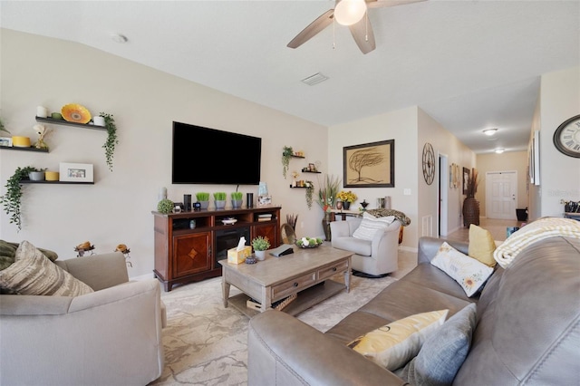 living area with visible vents and ceiling fan