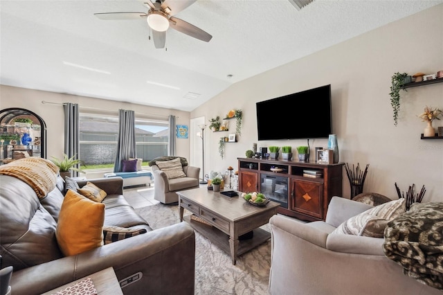 tiled living area with lofted ceiling, a textured ceiling, and a ceiling fan