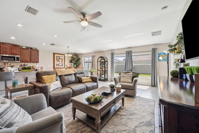 living area featuring recessed lighting, light tile patterned flooring, visible vents, and a ceiling fan