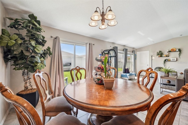 dining area featuring light tile patterned floors and a notable chandelier