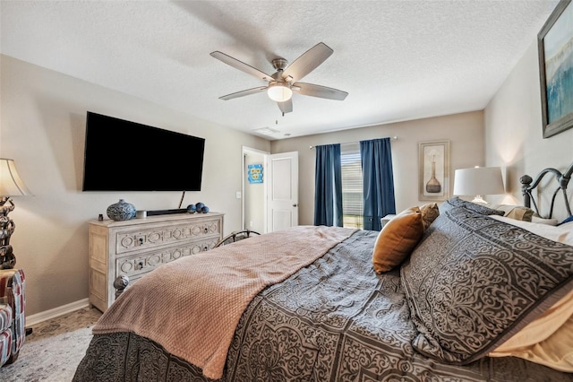 bedroom with ceiling fan, a textured ceiling, and baseboards