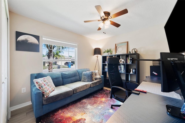 home office featuring ceiling fan, baseboards, and wood finished floors