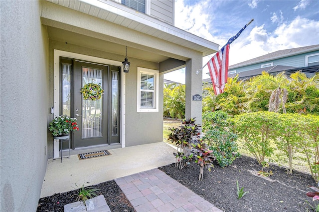 entrance to property with stucco siding