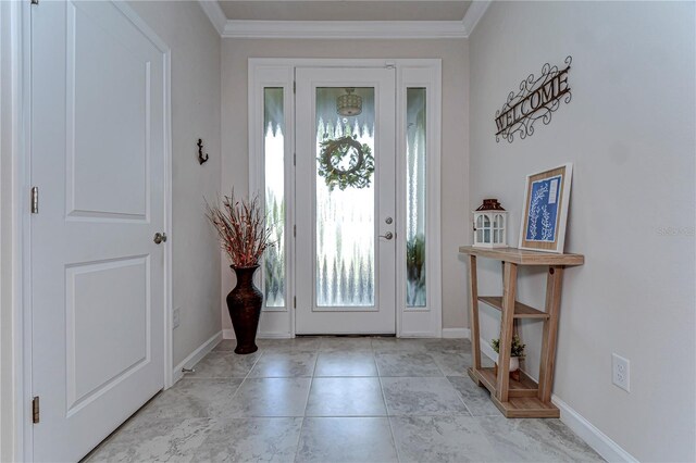 entrance foyer with ornamental molding, baseboards, and light tile patterned floors