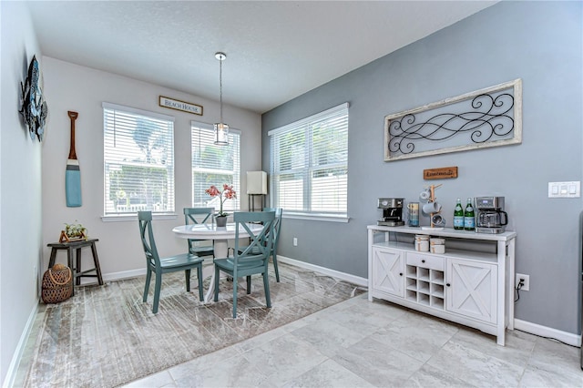 dining area featuring baseboards