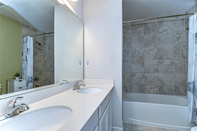 bathroom with double vanity, visible vents, a sink, and shower / bath combo with shower curtain