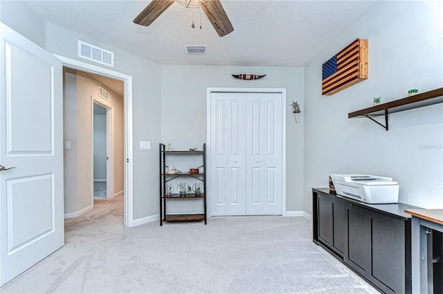 interior space featuring a closet, visible vents, light carpet, and baseboards