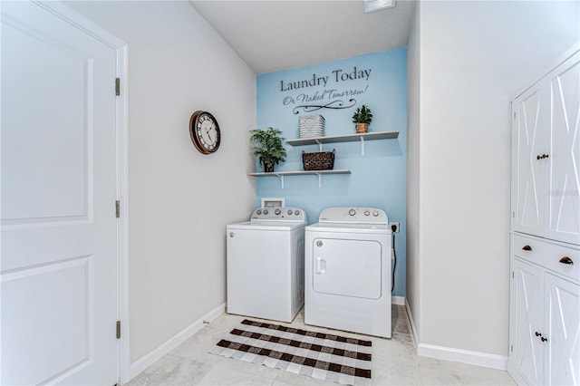 washroom with laundry area, separate washer and dryer, and baseboards