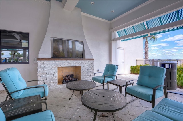 view of patio / terrace featuring fence and an outdoor living space with a fireplace