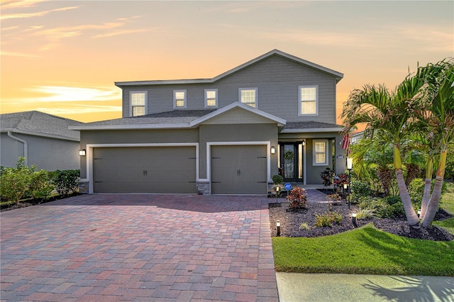 11605 Cleyera Ct, Riverview, FL 33579 - view of front of home featuring decorative driveway, an attached garage, and stucco siding
