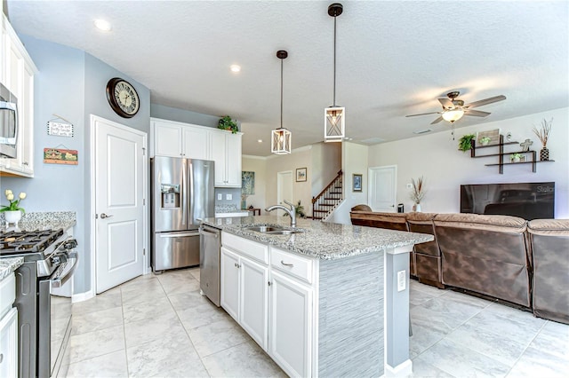 11605 Cleyera Ct, Riverview, FL 33579 - kitchen featuring stainless steel appliances, a sink, light stone countertops, white cabinetry, and recessed lighting