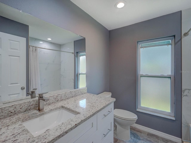 full bathroom with toilet, vanity, wood finished floors, a shower with curtain, and baseboards