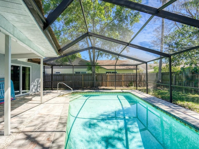 view of swimming pool featuring a patio area, a fenced backyard, glass enclosure, and a fenced in pool