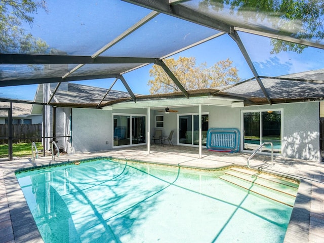 back of house with a lanai, a patio area, ceiling fan, and stucco siding