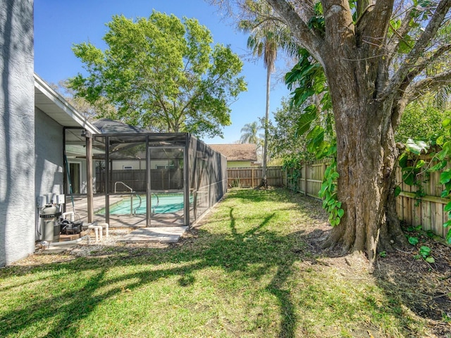 view of yard featuring a lanai, a fenced backyard, and a fenced in pool