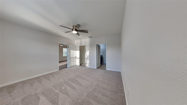 unfurnished bedroom featuring a ceiling fan, visible vents, carpet, baseboards, and ensuite bathroom