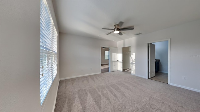 unfurnished bedroom featuring visible vents, carpet floors, baseboards, and ensuite bathroom