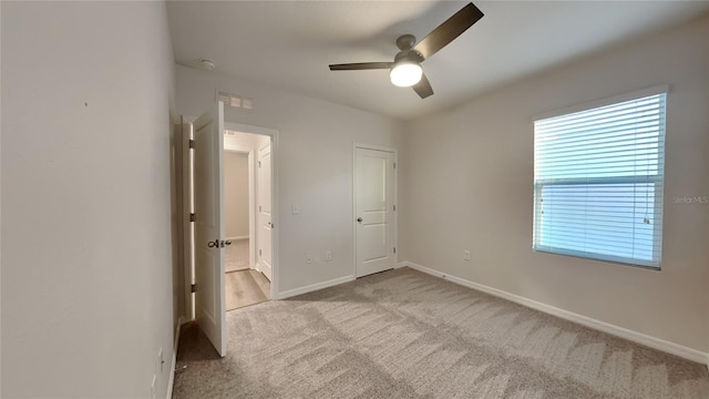 unfurnished bedroom featuring visible vents, ceiling fan, baseboards, and carpet floors