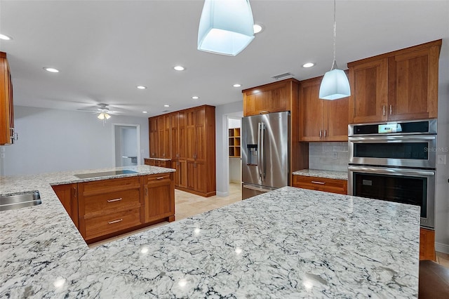 kitchen with tasteful backsplash, stainless steel appliances, a peninsula, light stone countertops, and ceiling fan