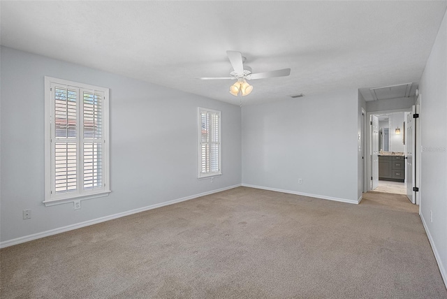 unfurnished bedroom with visible vents, baseboards, carpet, and attic access