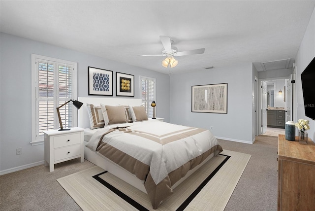 bedroom featuring light colored carpet, attic access, baseboards, and ceiling fan