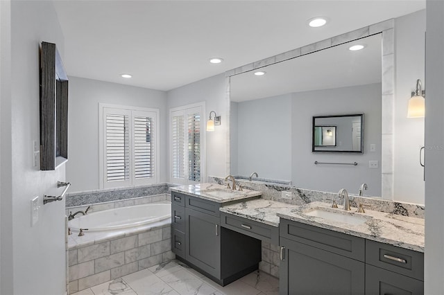 full bathroom with double vanity, recessed lighting, a sink, a bath, and marble finish floor