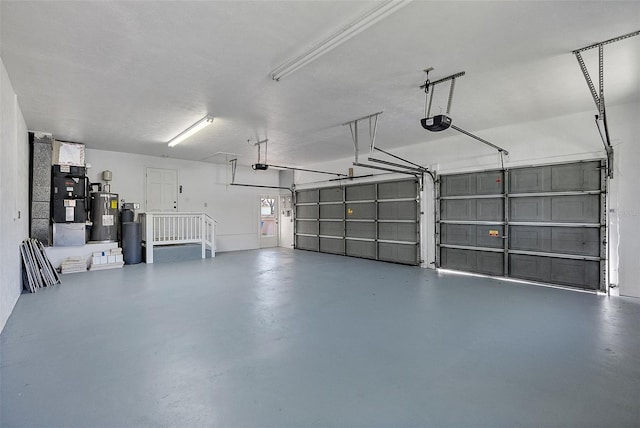 garage featuring heating unit, a garage door opener, and water heater