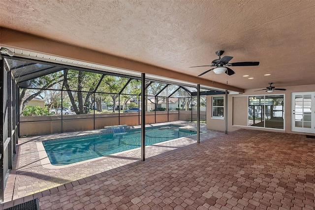 view of pool with a patio area, a fenced in pool, a lanai, and a ceiling fan