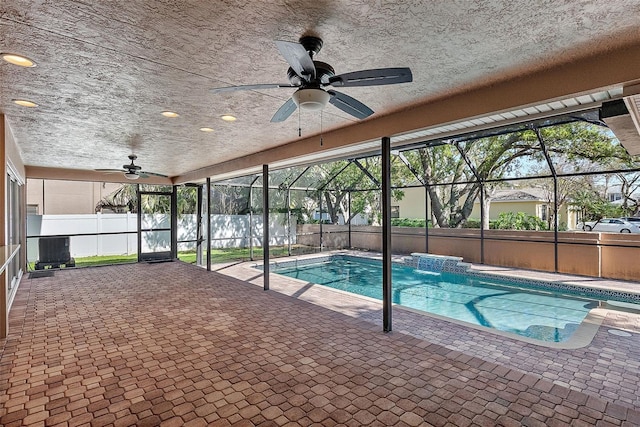 view of swimming pool with a lanai, ceiling fan, a patio, and fence