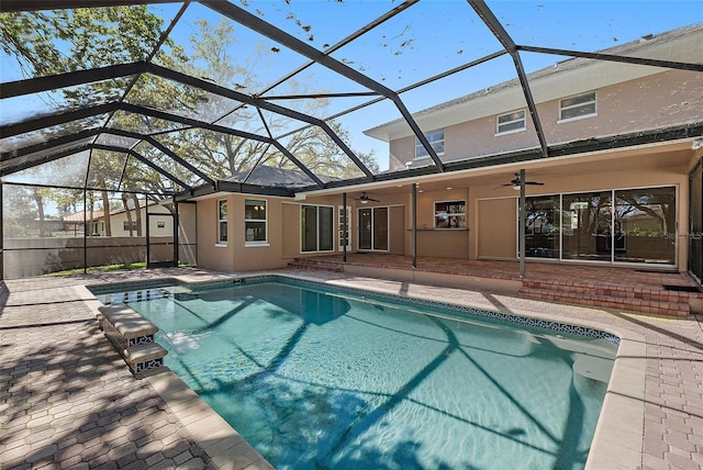 pool featuring a patio area, a lanai, and ceiling fan