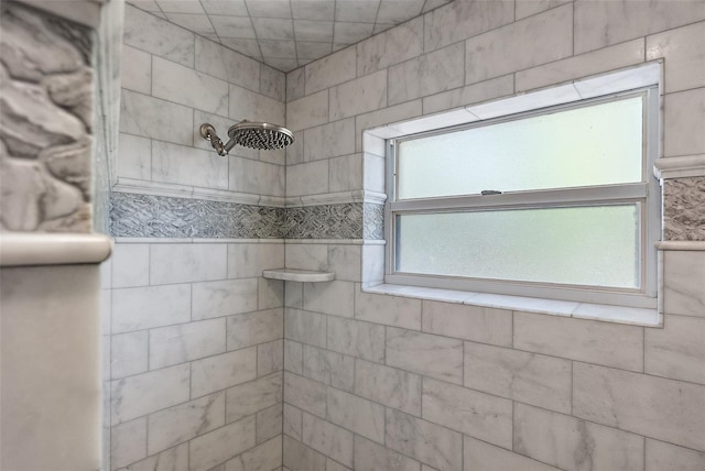 bathroom with a tile shower