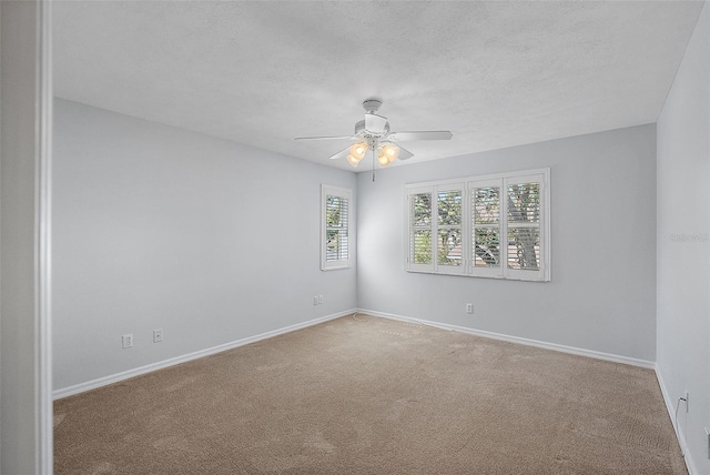 unfurnished room with baseboards, carpet floors, a textured ceiling, and ceiling fan