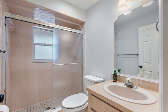 bathroom with a stall shower, toilet, and vanity